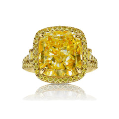 Unique light yellow cushion diamond ring with yellow diamond halo setting.