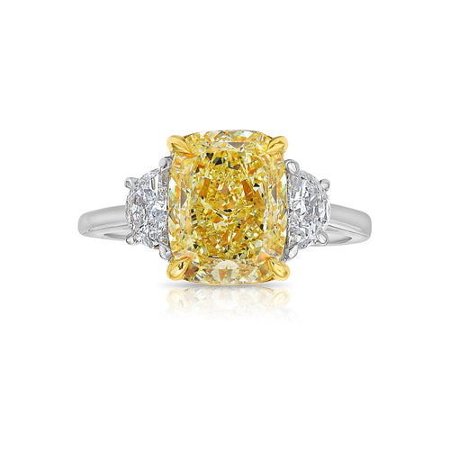 3ct Fancy Light Yellow Elongated Cushion Three Stone Diamond Ring.