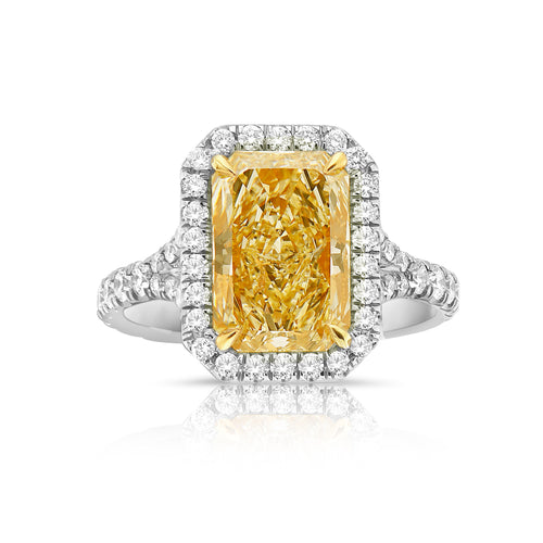 Unique Yellow diamond ring with white surrounding diamonds.