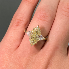 GIA certified yellow marquise cut diamond ring featuring a light yellow center diamond with excellent cut.