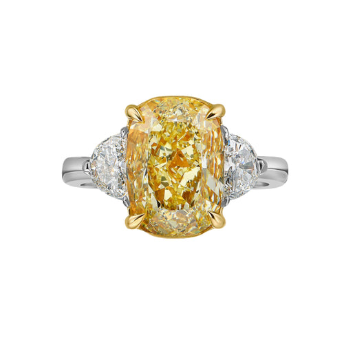 Unique Three-stone ring featuring a GIA-certified fancy yellow elongated cushion diamond with VVS2 clarity.