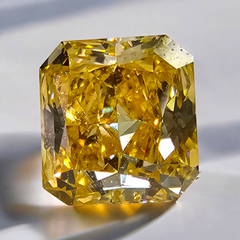 Vivid orange yellow radiant diamond with GIA certification and exceptional VVS1 clarity.