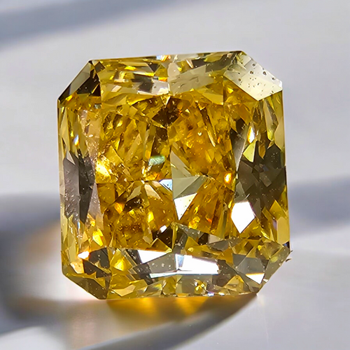 Vivid orange yellow radiant diamond with GIA certification and exceptional VVS1 clarity.