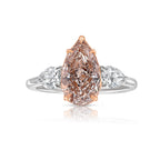 Elegant pink pear-shaped diamond engagement ring with VS1 clarity and sparkling side stones.