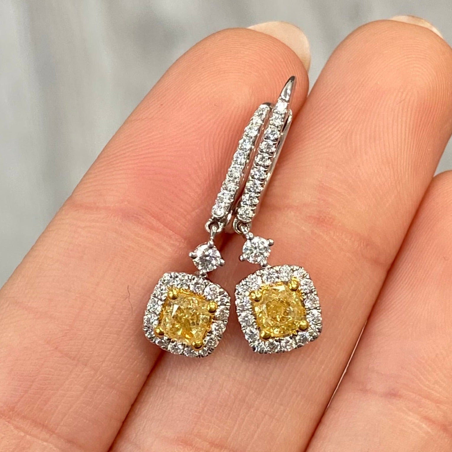 Natural canary diamond earrings in halo design