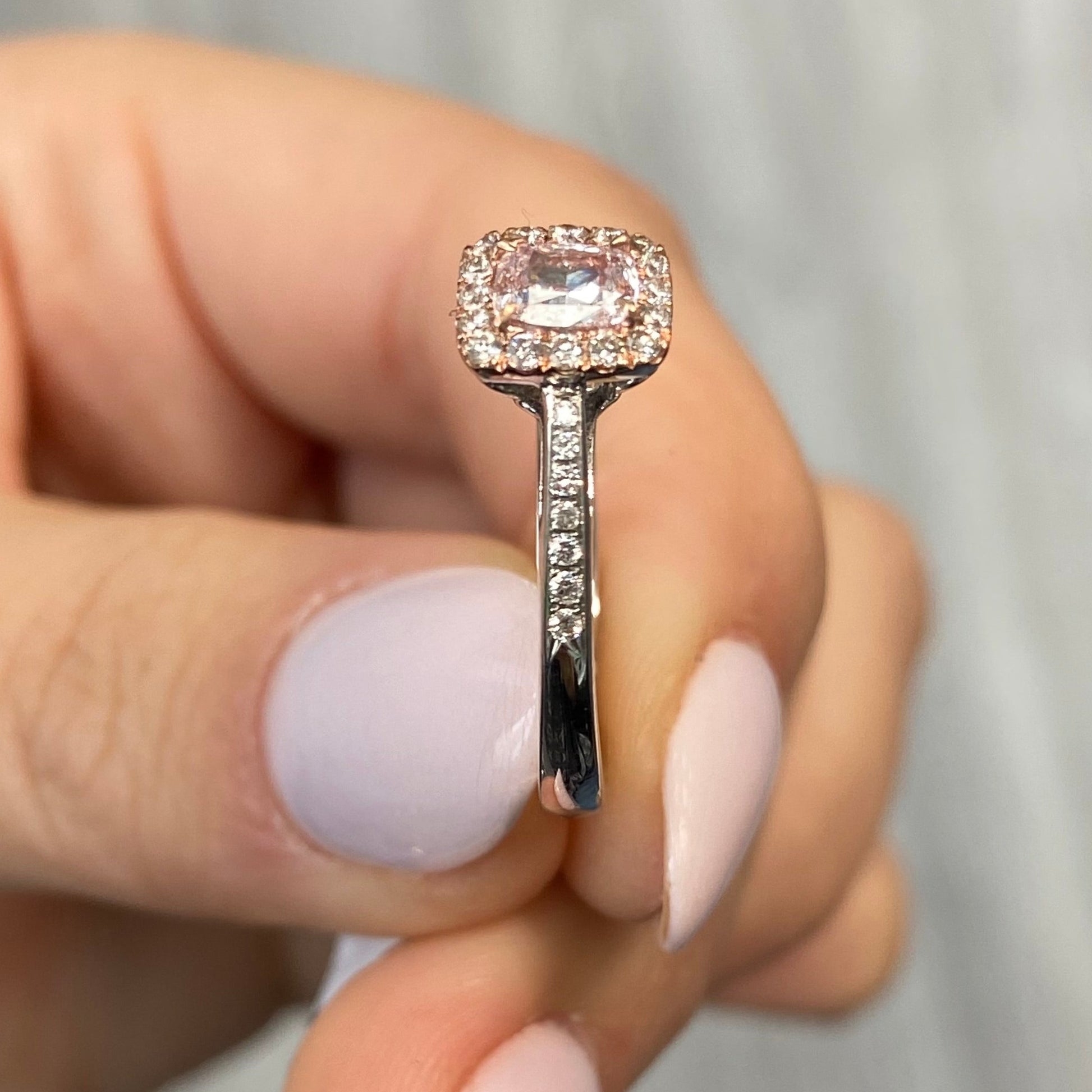 Pink diamond ring. pink diamond engagement ring. light pink diamonds. light pink cushions. diamond ring.