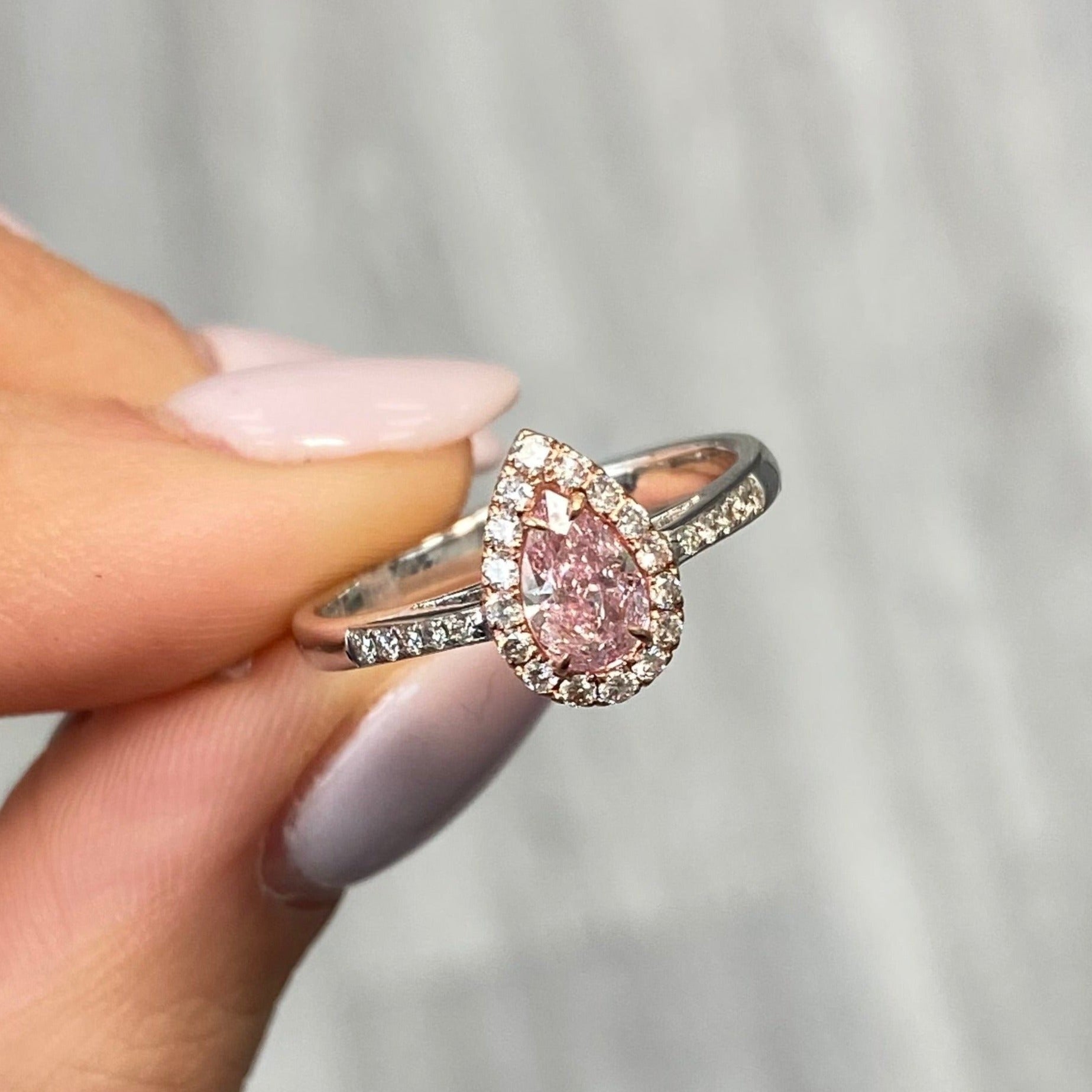 Pink diamond ring. pink diamond engagement ring. light pink diamonds. light pink pear shape. diamond ring. Pear diamond ring.