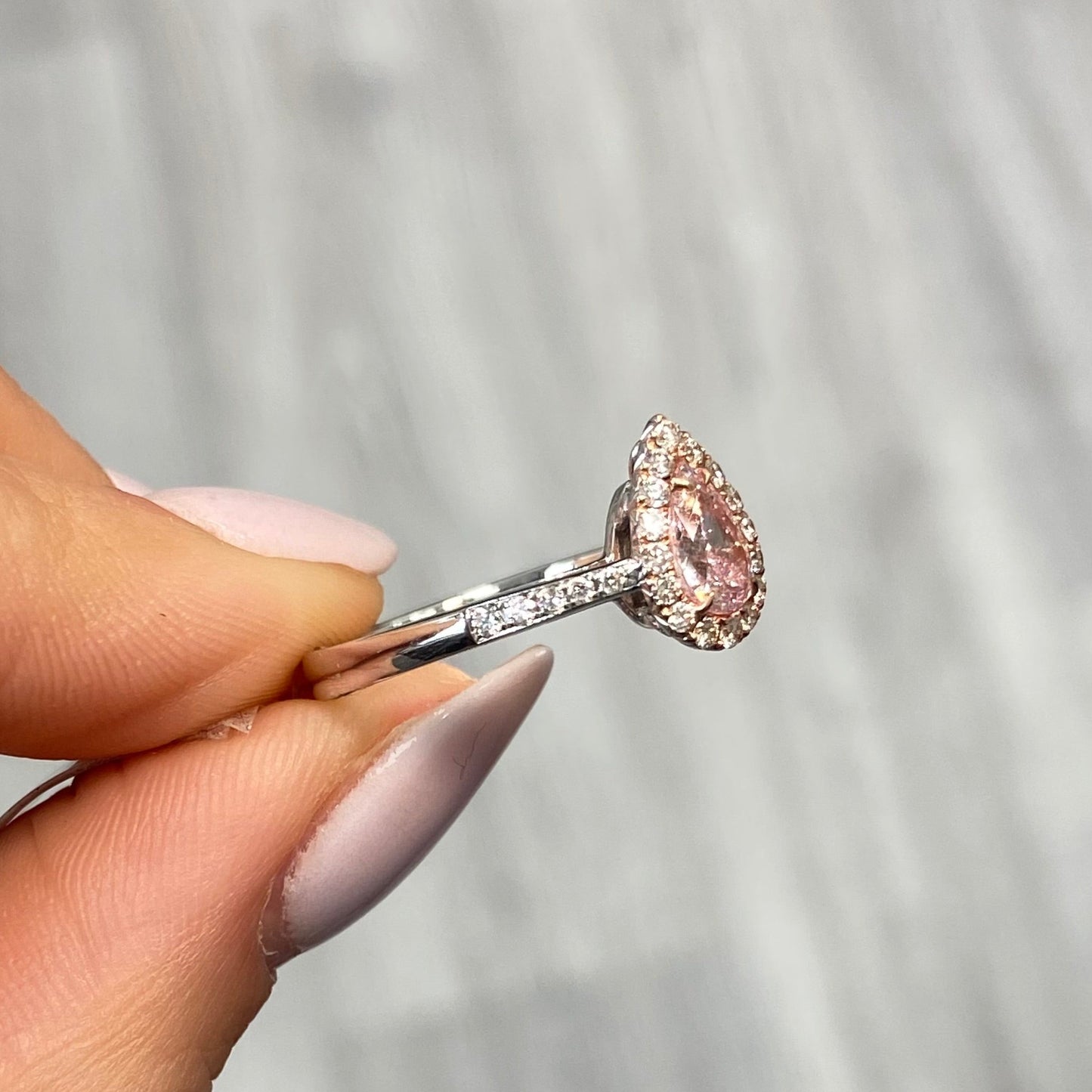 Pink diamond ring. pink diamond engagement ring. light pink diamonds. light pink pear shape. diamond ring. Pear diamond ring.