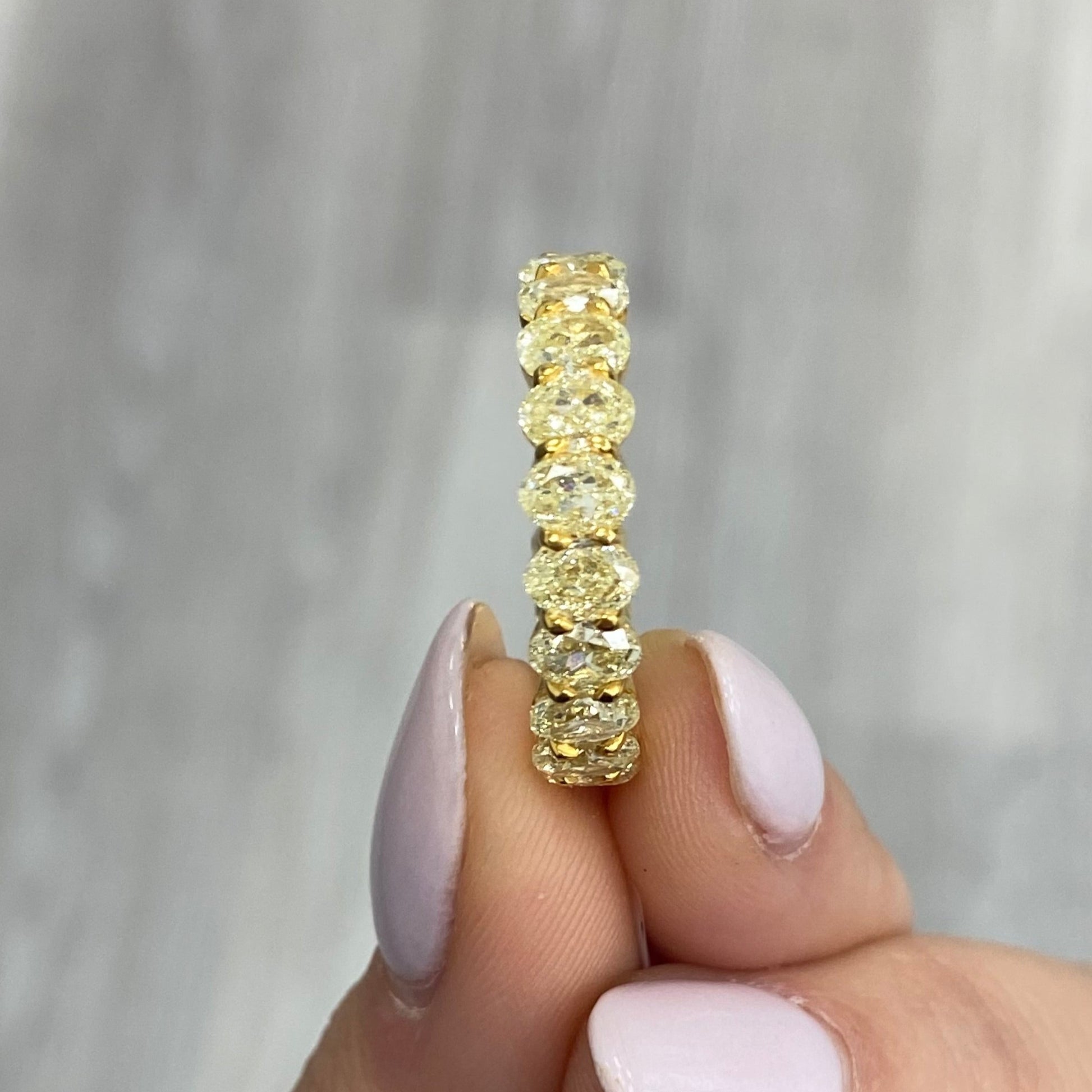 Oval diamond eternity ring. Yellow diamond oval eternity ring. Yellow diamond band. Canary diamond band. Yellow oval diamonds. Fancy yellow oval diamond ring. Yellow diamond stackable rings.