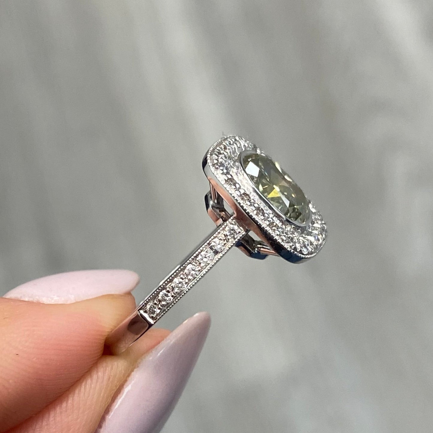 unique style green diamond ring surrounded by white diamonds handmade in white gold