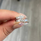 pink diamond statement ring, pink and white pear shape diamonds with emerald cut diamonds along the band