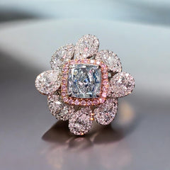 Unique multicolor Natural Blue Diamond Ring with a fancy light blue cushion cut center diamond.