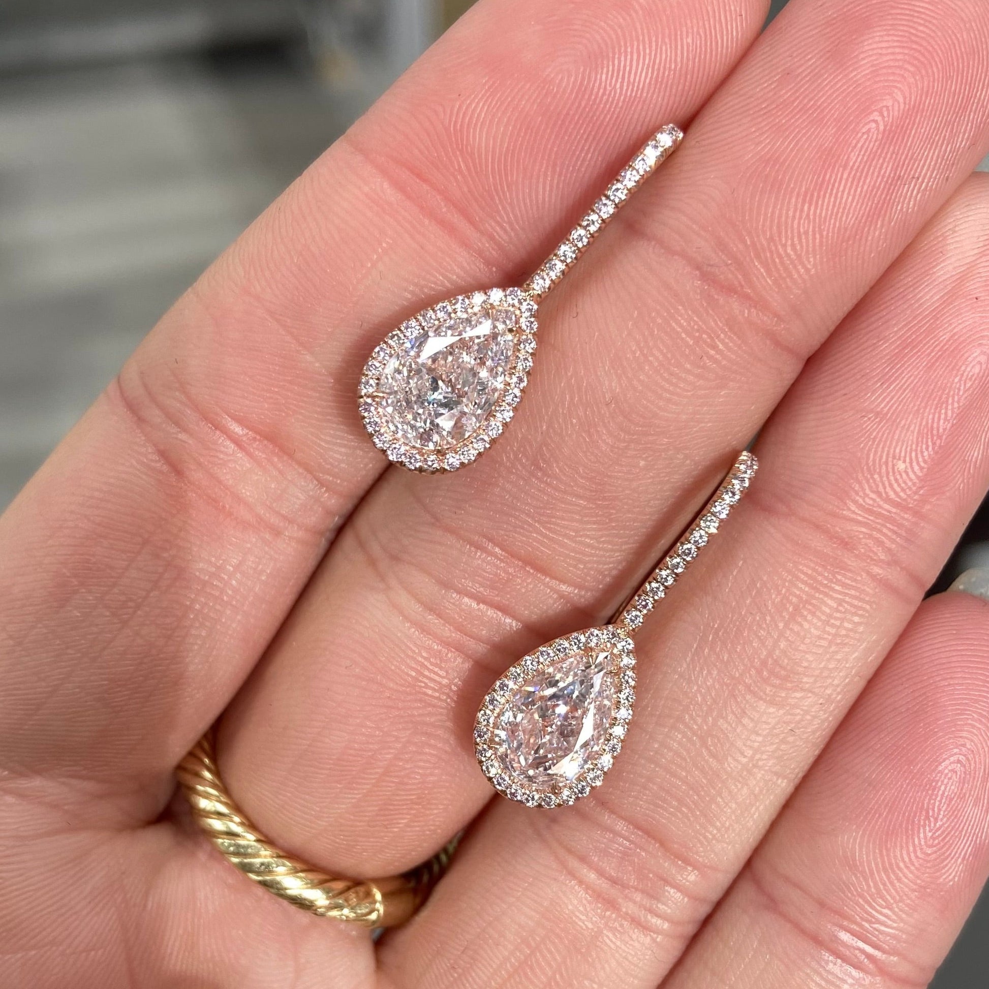 Handmade rose gold earrings featuring a rare matched pair of 2 carat each light pink pear shape diamonds and round pink diamonds