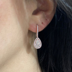 Handmade rose gold earrings featuring a rare matched pair of 2 carat each light pink pear shape diamonds and round pink diamonds