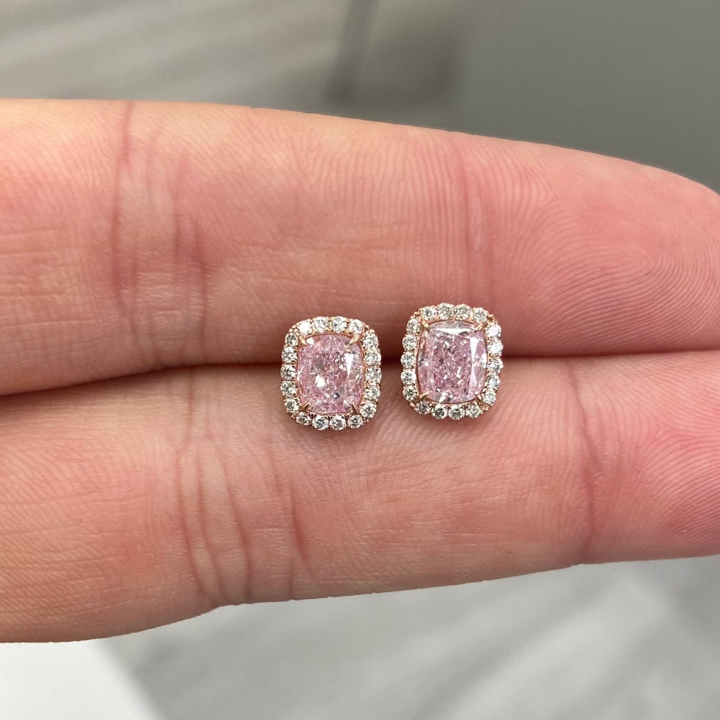Pink diamond earrings. pink diamond studs. light pink diamonds. light pink cushions. diamond earrings.