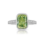 GIA certified natural greenish yellow diamond engagement ring with elongated cushion cut center diamond and VS2 clarity.