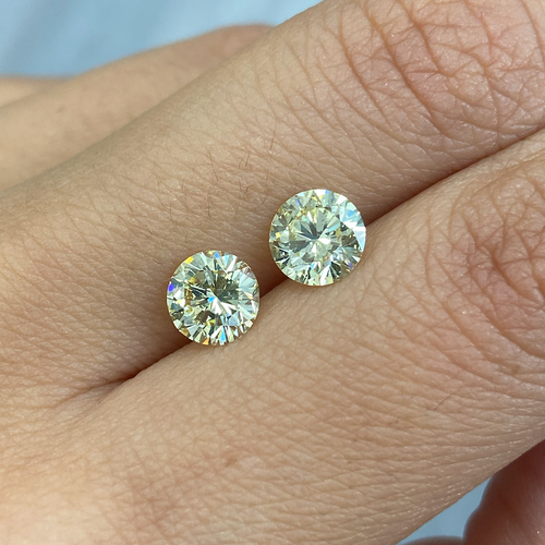 GIA certified matched pair of 2 round natural yellow diamonds.