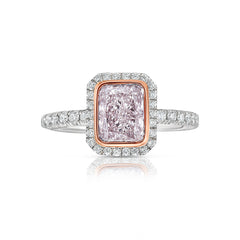 Pink diamond engagement ring surrounded by a white diamond halo.