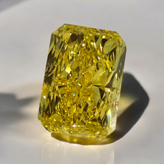 Fancy vivid yellow natural diamond, elongated radiant cut diamond.