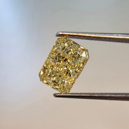 GIA certified Fancy Yellow elongated radiant cut natural diamond with exquisite clarity.