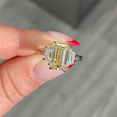 Light yellow emerald-cut diamond ring with excellent cut, VS2 clarity, and GIA certification.