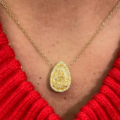 Elegant GIA certified pear shaped canary diamond necklace in yellow gold with yellow diamonds.