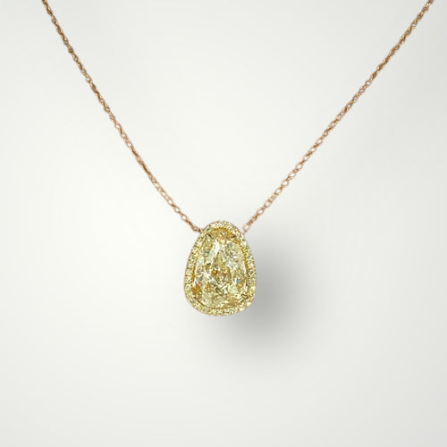 Elegant pear-shaped diamond pendant encircled by a halo of yellow diamonds.