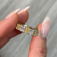 Elegant yellow and white radiant cut diamond eternity band featuring VS-VVS clarity.