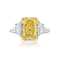 Fancy engagement ring with a yellow diamond center and two white diamonds on the sides.