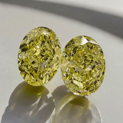 GIA certified matched pair of 2 natural yellow oval diamonds.