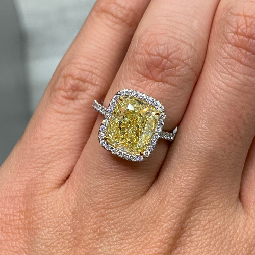 GIA certified natural canary yellow diamond ring surrounded by a halo of white diamonds.