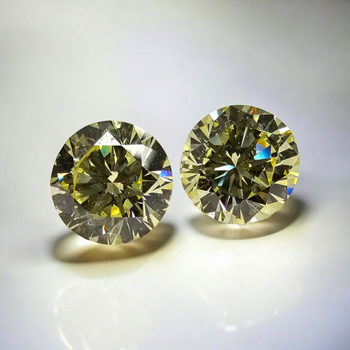 GIA certified matched pair of 2 round natural yellow diamonds.