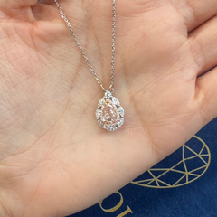 Unique natural pink diamond pendant featuring a pear shaped gem with a delicate hue.