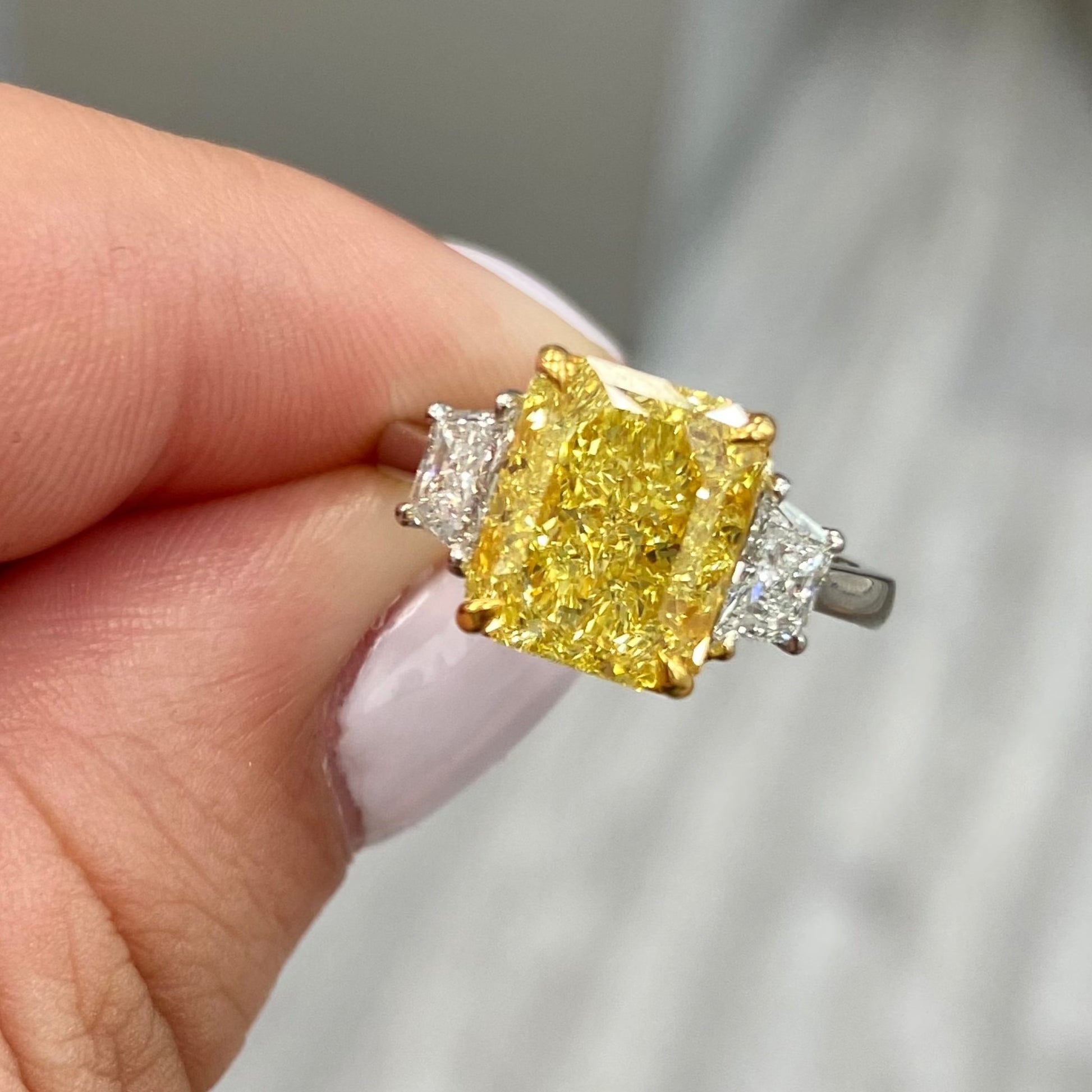 Fancy intense yellow elongated radiant diamond ring. Fancy intense yellow diamond. Intense yellow diamond ring. Elongated radiant. 
