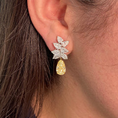 Fancy Light Yellow pear shape diamond earrings Natural yellow pear shape diamond cluster drop earrings with a total of 13.29 carats of natural white and yellow diamonds. Featuring 3 carat each, GIA Certified Fancy Light Yellow pear shape center diamonds with VS1 and VVS2 clarity.