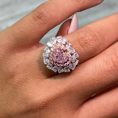 Pink heart shape diamond with white and pink surrounding diamonds.