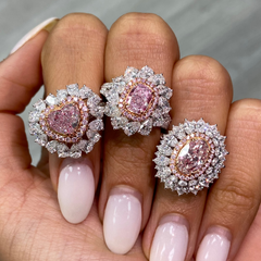 Pink heart shape diamond with white and pink surrounding diamonds.