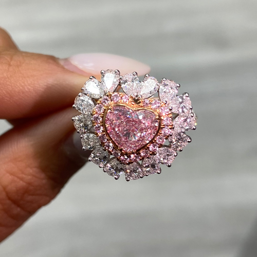 Pink heart shape diamond with white and pink surrounding diamonds.