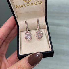 Handmade rose gold earrings featuring a rare matched pair of 2 carat each light pink pear shape diamonds and round pink diamonds.