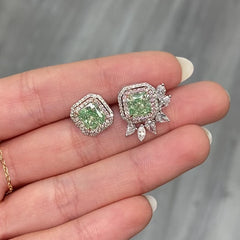 Unique green diamond stud earrings surrounded by natural pink and white diamond halos.