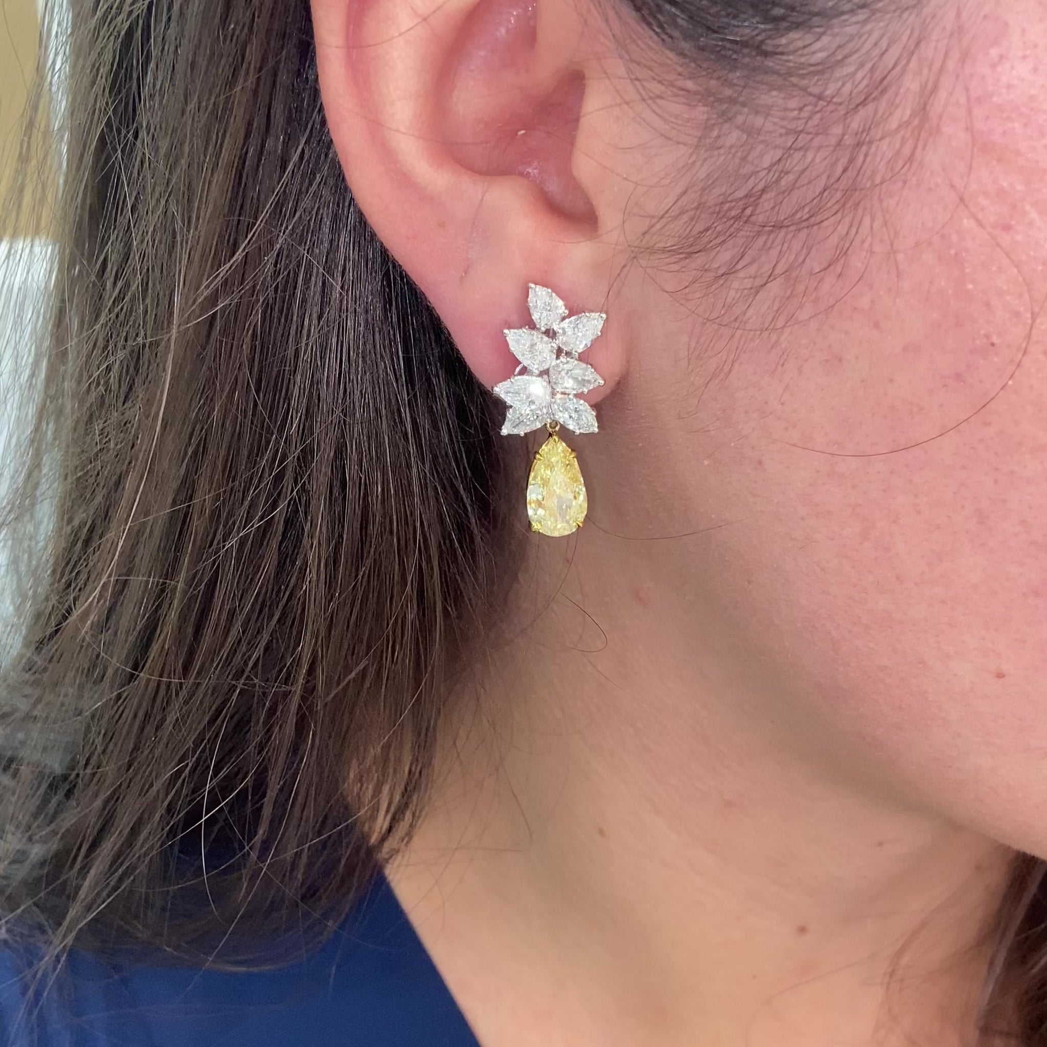 Fancy Light Yellow pear shape diamond earrings Natural yellow pear shape diamond cluster drop earrings with a total of 13.29 carats of natural white and yellow diamonds. Featuring 3 carat each, GIA Certified Fancy Light Yellow pear shape center diamonds with VS1 and VVS2 clarity.