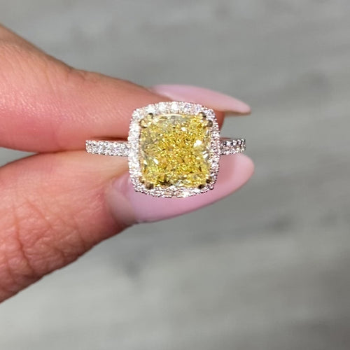 Yellow diamond ring with white halo diamonds