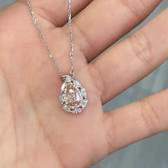 Unique natural pink diamond pendant featuring a pear shaped gem with a delicate hue.