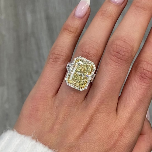 GIA certified elongated radiant yellow diamond halo ring, featuring a soft and sweet yellow hue.