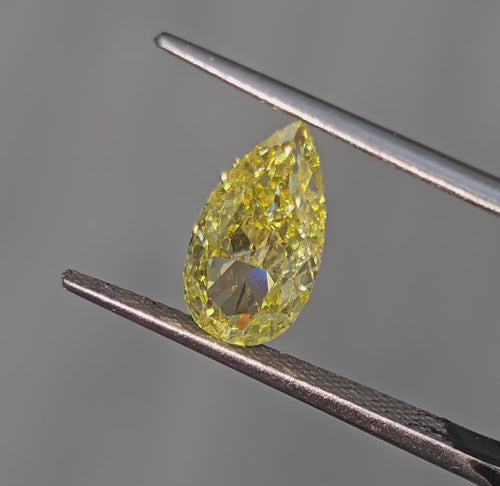 GIA certified fancy Intense Yellow pear-shaped diamond with SI1 clarity and vibrant brilliance.