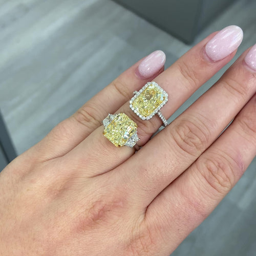 5.34 Carat Fancy Light Yellow Radiant Three Stone Diamond Ring next to a halo ring of the same size