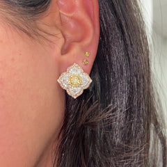 Light yellow and fancy light yellow diamond studs, in a flower theme with 1.5 carats of surrounding white and yellow diamonds