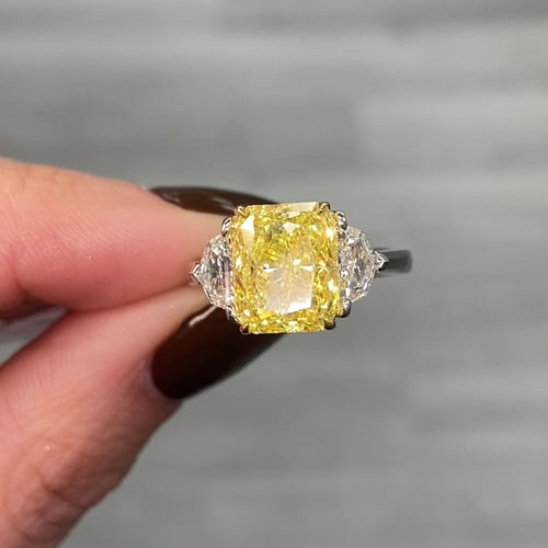 GIA certified fancy vivid yellow elongated radiant diamond engagement ring, internally flawless and stunning.