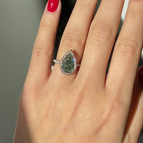 GIA certified fancy pear shaped green ring with pink diamonds. 