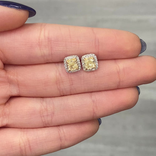 Fancy Light Yellow Cushion Diamond Studs 1.42 carat total center diamonds  Center diamonds are 0.71ct each  Surrounded by 0.22 Carats of White Radiant Diamonds Set in 18k Gold Handmade in NYC 